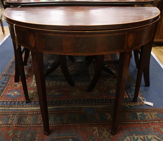 A Georgian inlaid mahogany tea table W.91cm